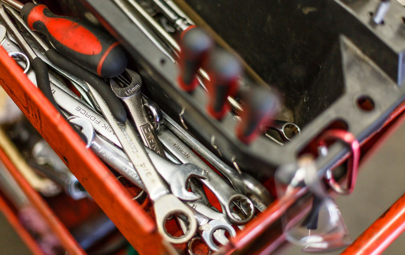 Professional wrenches organized in a red toolbox